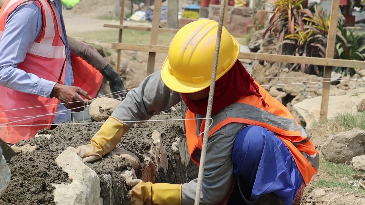 Site crew in hard hats and high-visibility vests at work on a project site